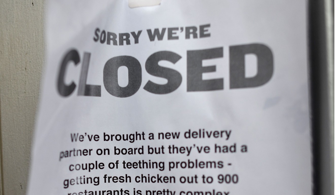 A sign outside a closed KFC fast food store in south London explains the closure is due to a shortage of fresh chicken. Photo: AFP