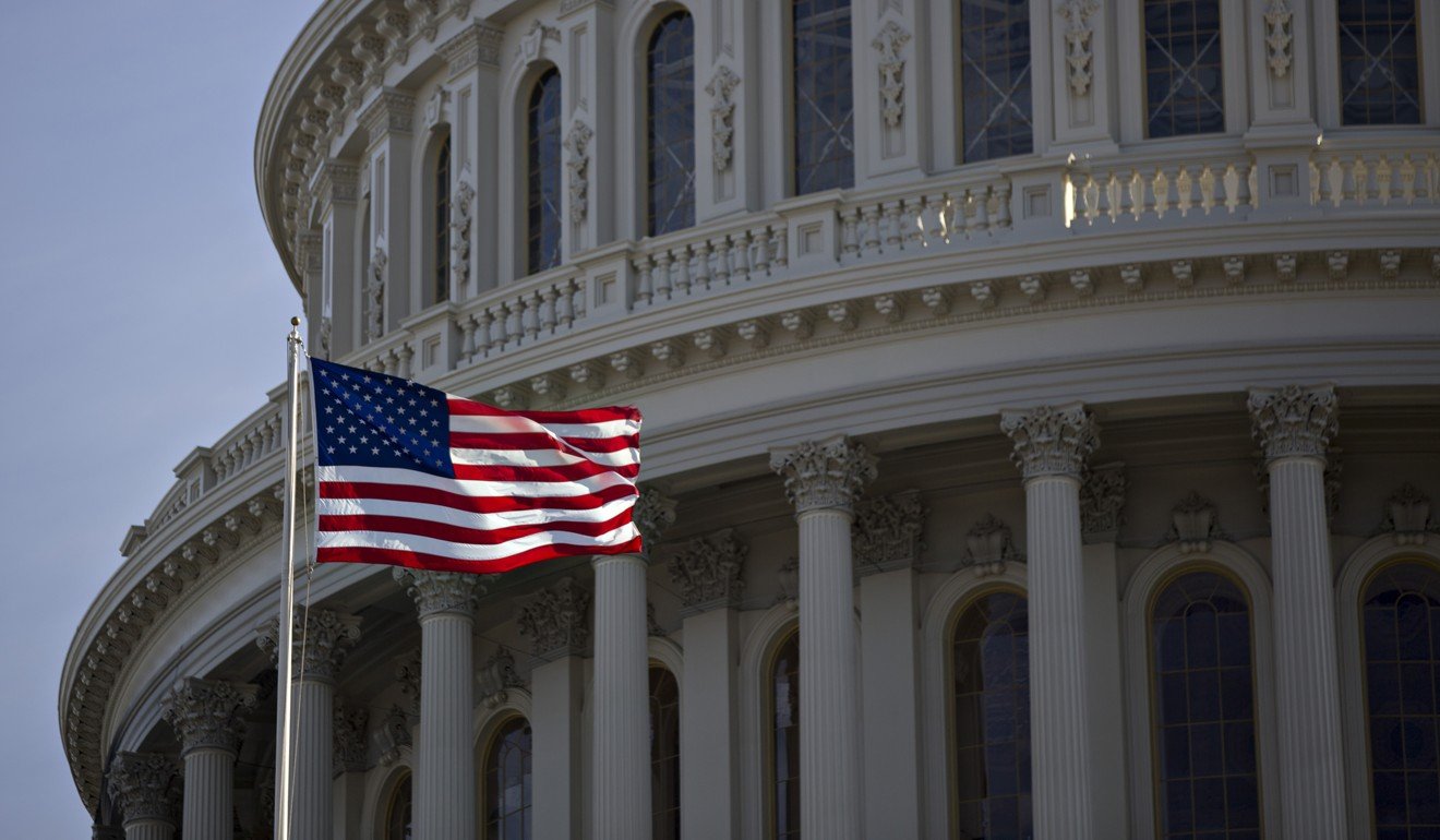 The American flag flies next to the dome of the US Capitol building on January 15. Too often, the West seeks to “improve” non-Western civilisations by turning them into its own image. Photo: Bloomberg