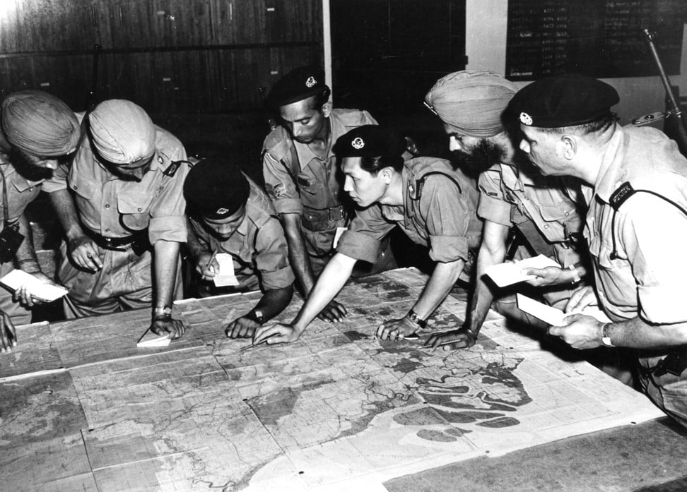 Inspector Tun Hamzah briefs section leaders before a night operation during the Malayan Emergency. The photo, taken in about 1958, is not part of a display in Singapore by journalist Sim Chi Yin journalist. Photo: Alamy