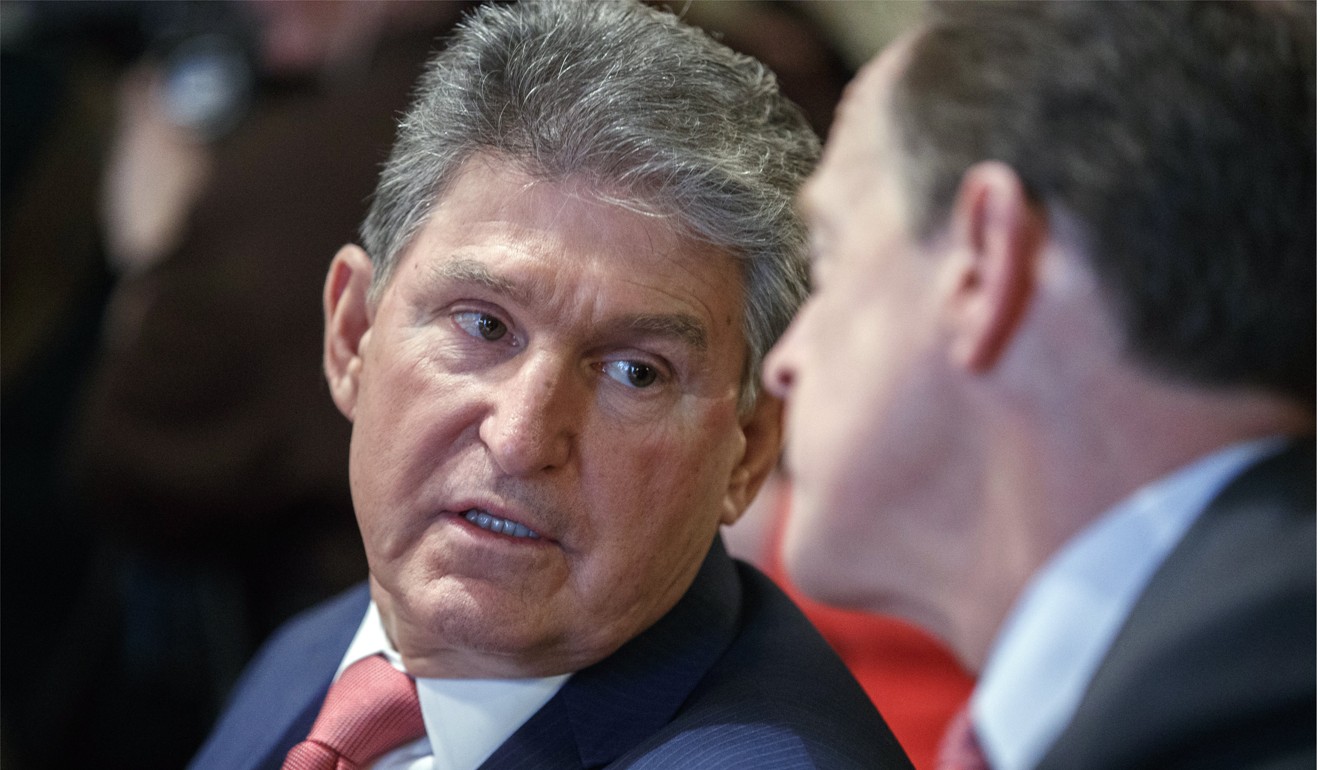 US Democratic Senator from West Virginia Joe Manchin (left) talks with US Republican Senator from Pennsylvania Pat Toomey on Wednesday. The pair previously proposed a bipartisan bill to improve background checks. Photo: EPA-EFE