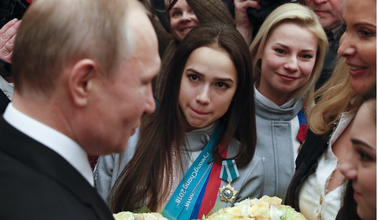 Russian President Vladimir Putin (left) speaks with skaters Alina Zagitova (2nd L) and Evgenia Medvedeva (R, bottom), their coach Eteri Tutberidze (R, top) and other medallists of the 2018 Pyeongchang Winter Olympic Games after a ceremony at the Kremlin in Moscow on Wednesday. Photo: Reuters