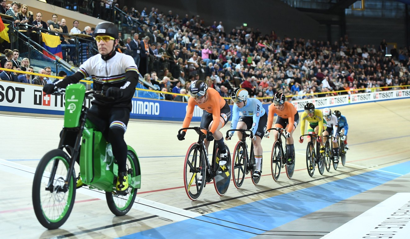 A man rides a derny ahead of cyclists in the women's keirin final. Photo: AFP