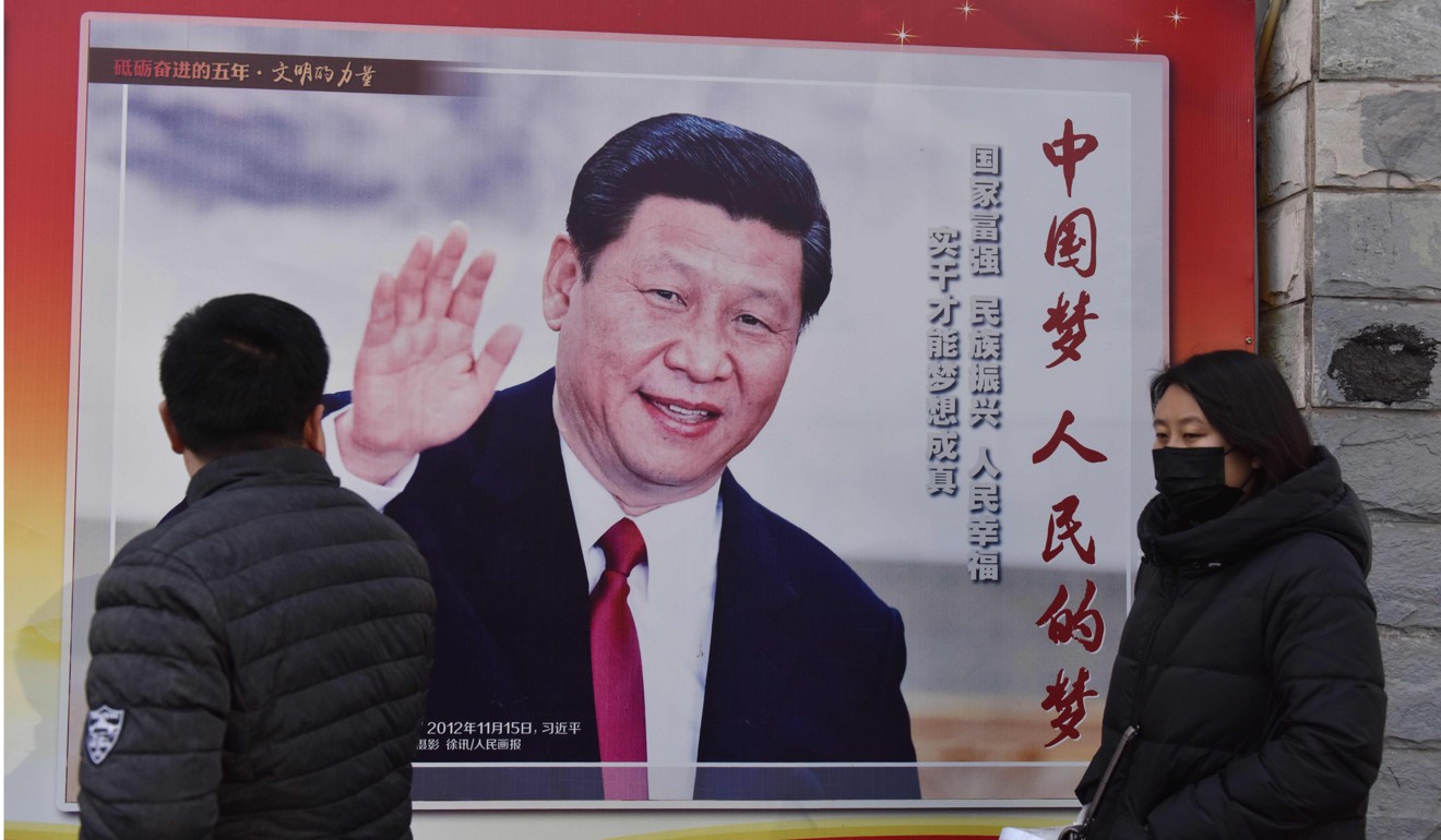 People walk past a poster of President Xi Jinping promoting the Chinese dream on a Beijing street last month.  Photo: AFP