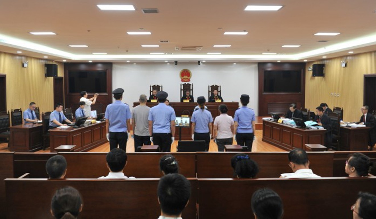 A photo taken inside Harbin City Intermediate People's Court on July 19, 2016, shows defendants Qu Zhang Mingjie (right, flanked by policewomen) and co-accused Wang Shaoyu at their corruption trial. Photo: Harbin City Intermediate People's Court