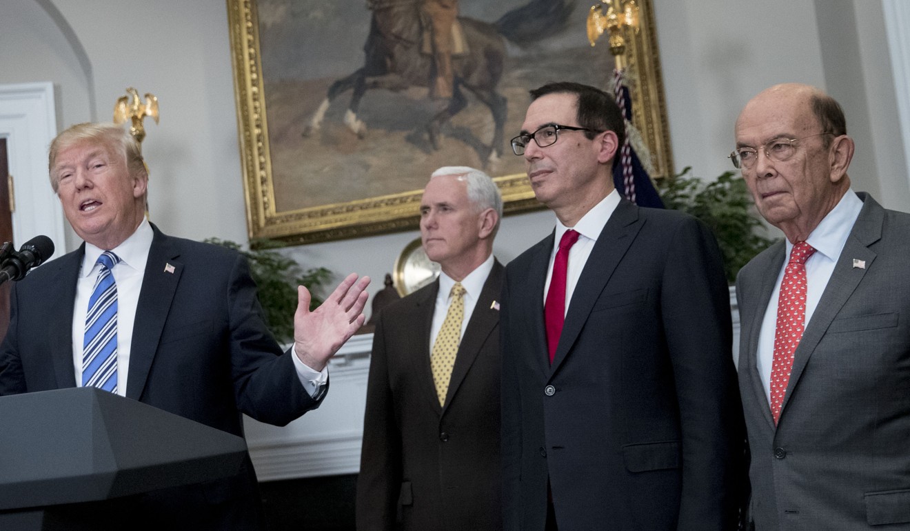 US President Donald Trump speaks as Wilbur Ross, commerce secretary, from right, Steven Mnuchin, treasury secretary, and Vice-President Mike Pence listen before he signs proclamations on adjusting imports of steel and aluminium into the United States in the Roosevelt Room of the White House, Mexico and Canada would likely not face the levies if they renegotiate the North American Free Trade Agreement. Photo: Bloomberg