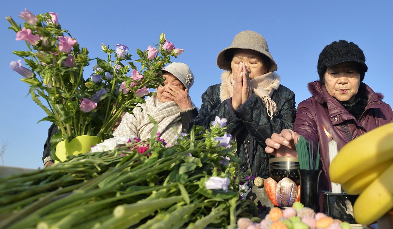 People living in temporary housing in the northeastern Japan city of Minamisoma mark the anniversary of the March 2011 earthquake and tsunami. Photo: Kyodo