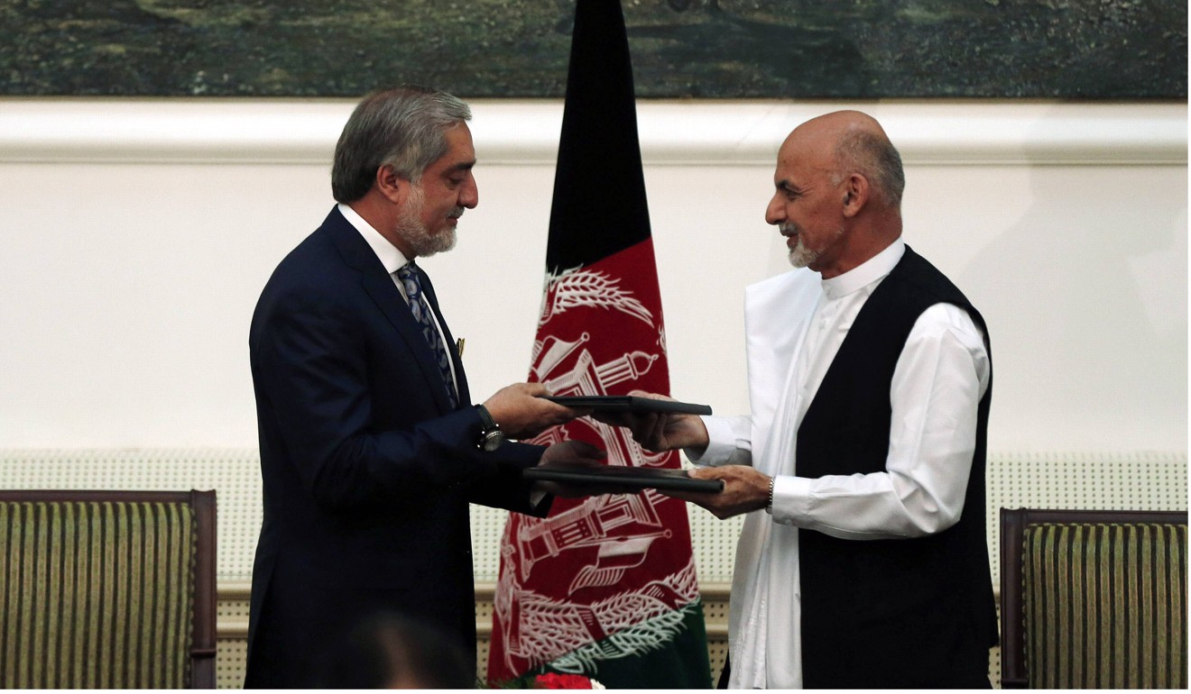Abdullah Abdullah and Ashraf Ghani exchange signed agreements for the country’s unity government following the disputed election. Photo: Reuters