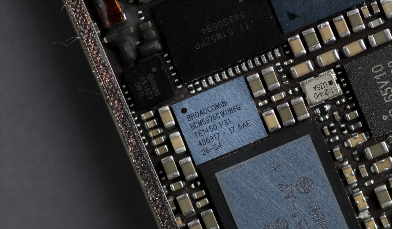A Broadcom touch screen digitiser integrated circuit chip of an Apple Inc iPhone 6 smartphone. Photo: Bloomberg