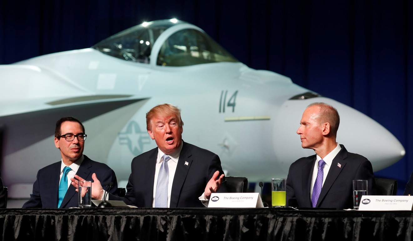 US President Donald Trump sits between Boeing Chairman and CEO Dennis Muilenburg (right) and Treasury Secretary Steve Mnuchin (left) during a round table at Boeing in St Louis, Missouri, on Wednesday. Photo: Reuters