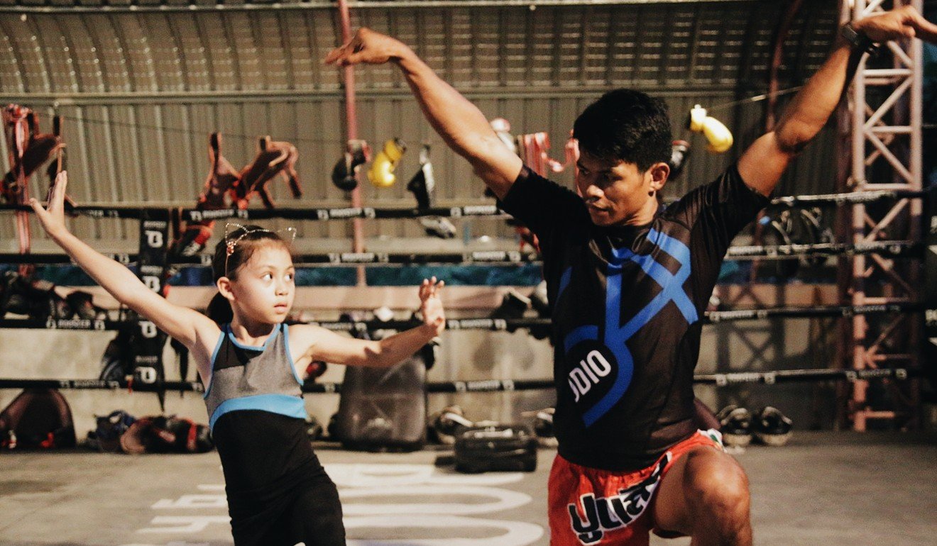 Boom shows a student Muay Thai moves at Wor. Watthana. Photo: Wor. Watthana
