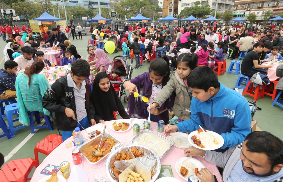 1,200 low income earners including the new arrivals and ethnic minorities attend a poon choi feast in Kwai Fong MTR. 20MAR16 SCMP/Dickson Lee
