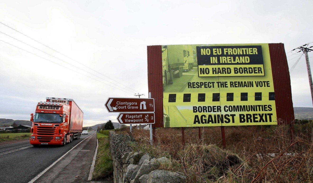 In this file photo taken on December 1, 2017 Traffic crosses the border into Northern Ireland from the Irish Republic alongside a Brexit Border poster on the Dublin road, between Newry in Northern Ireland and Dundalk in the Irish Republic. Photo: AFP 