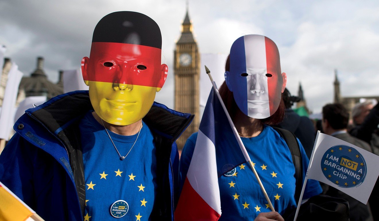 Protesters wearing the German and French flags posing for a photograph in February during a pro-EU-migrant ‘Flag Mob’ demonstration in Parliament Square in central London. Photo: AFP