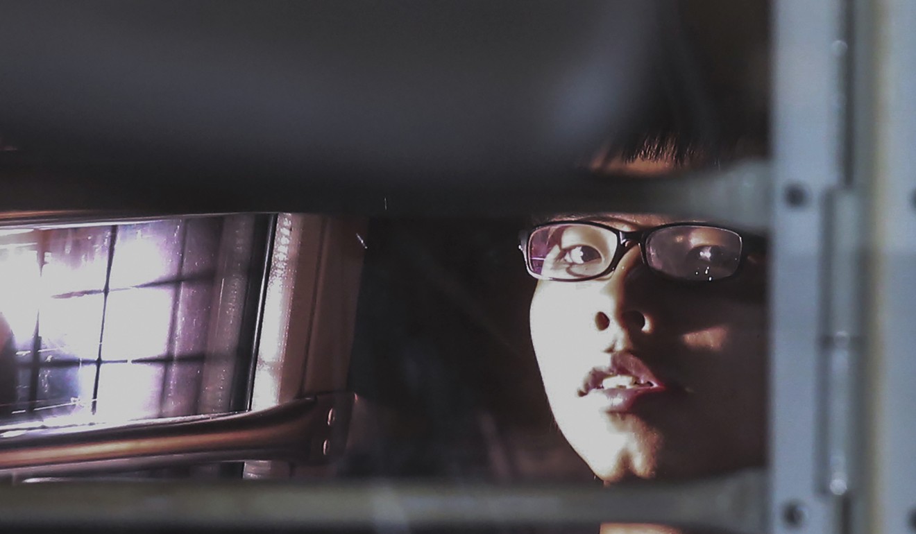 Post photographer Cheng Kwok-yin won a merit prize for this photo of student activist Joshua Wong leaving the High Court in a correctional services department vehicle, after he was sentenced to jail over the 2014 Occupy protests. Photo: K. Y. Cheng