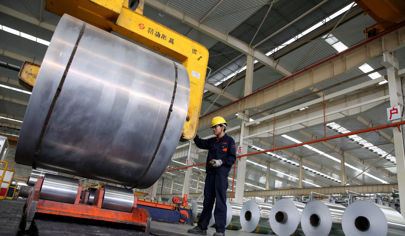 A worker checks aluminium tapes at a plant in Huaibei, east China's Anhui province. Photo: AFP