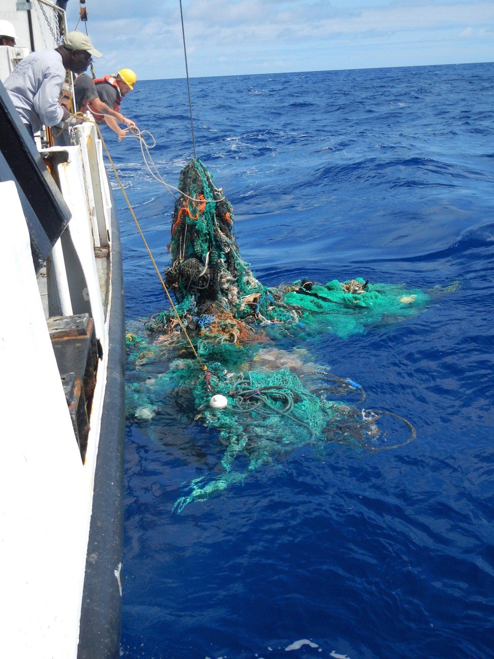 This handout photo released on March 22 by the Ocean Cleanup shows Mega Expedition mother ship R/V Ocean Starr crew pulling a discarded net from the Pacific Ocean in 2015. Photo: Agence France-Presse