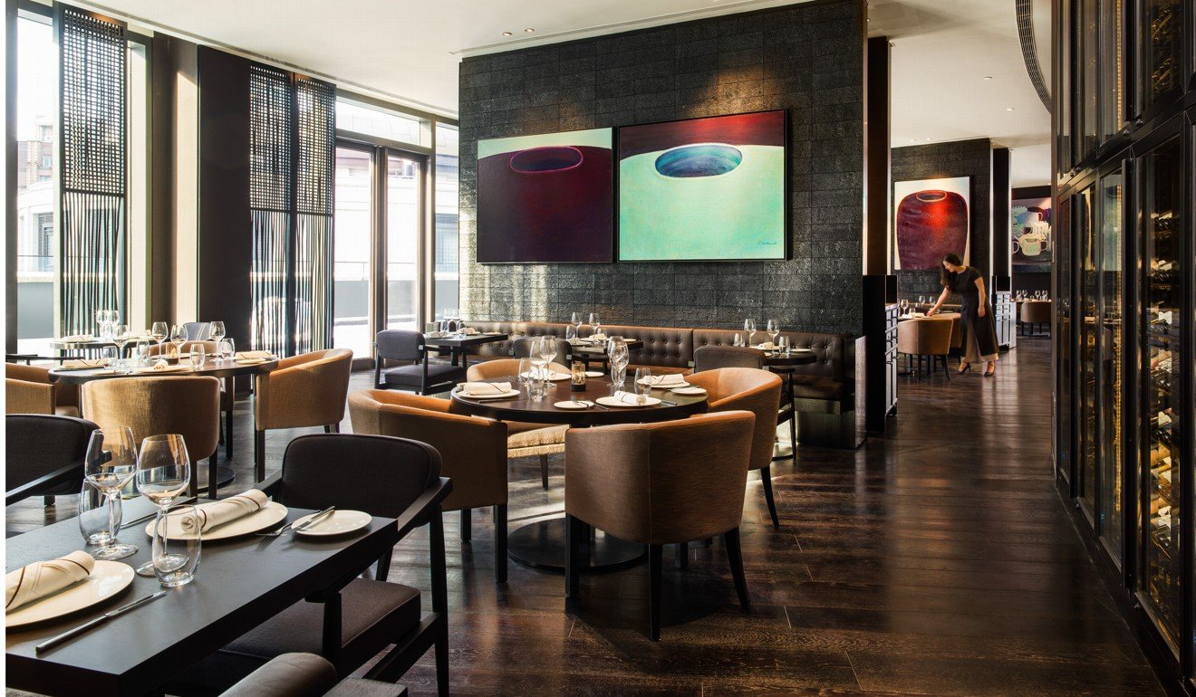 A series of paintings by the Hong Kong artist Richard Winkworth decorate floor-to-ceiling panels in the hotel’s Gray Deluxe dining area. Photo: Michael Weber