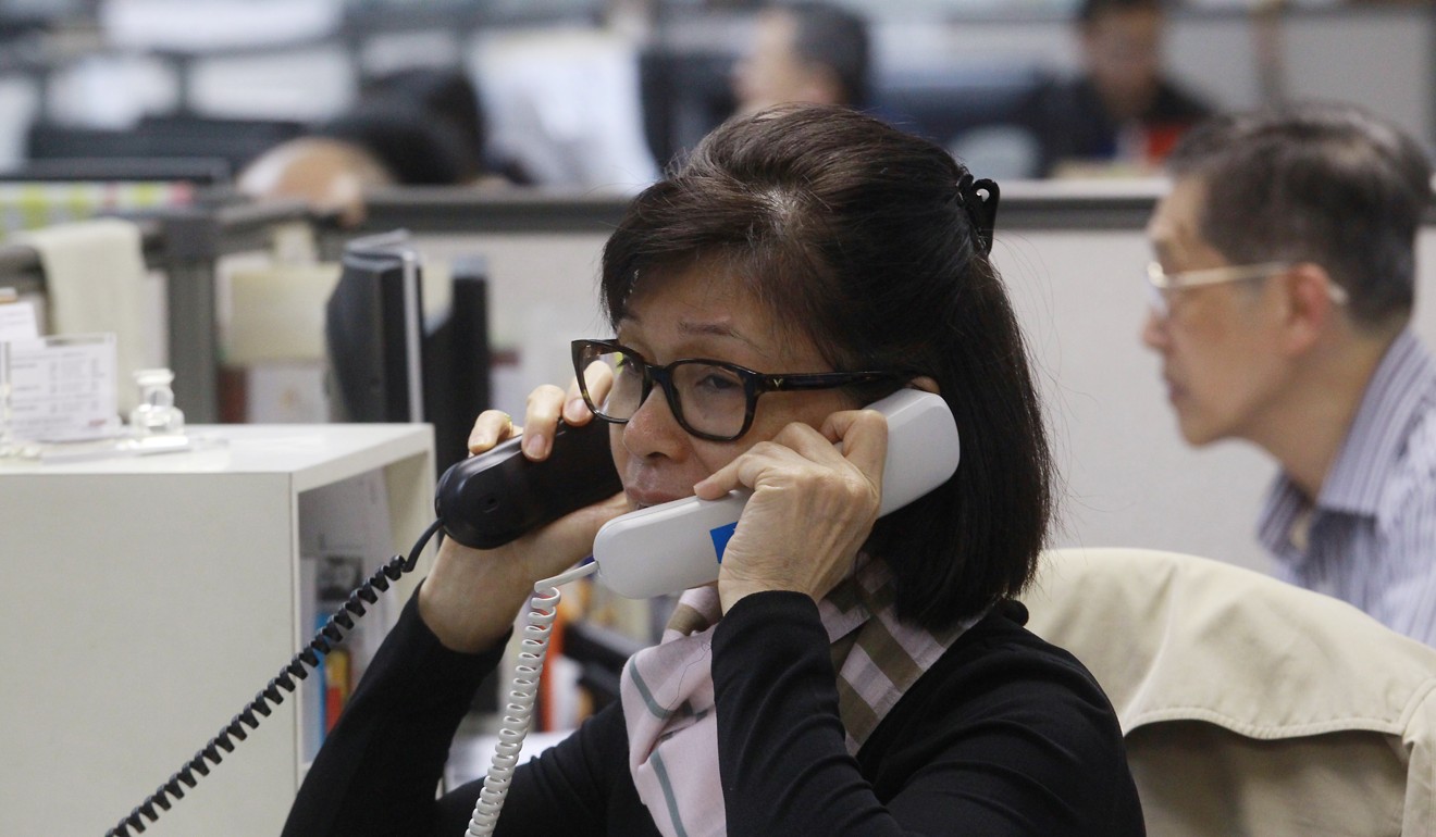 A broker takes an order at Prudential Brokerage in Central. Photo: SCMP