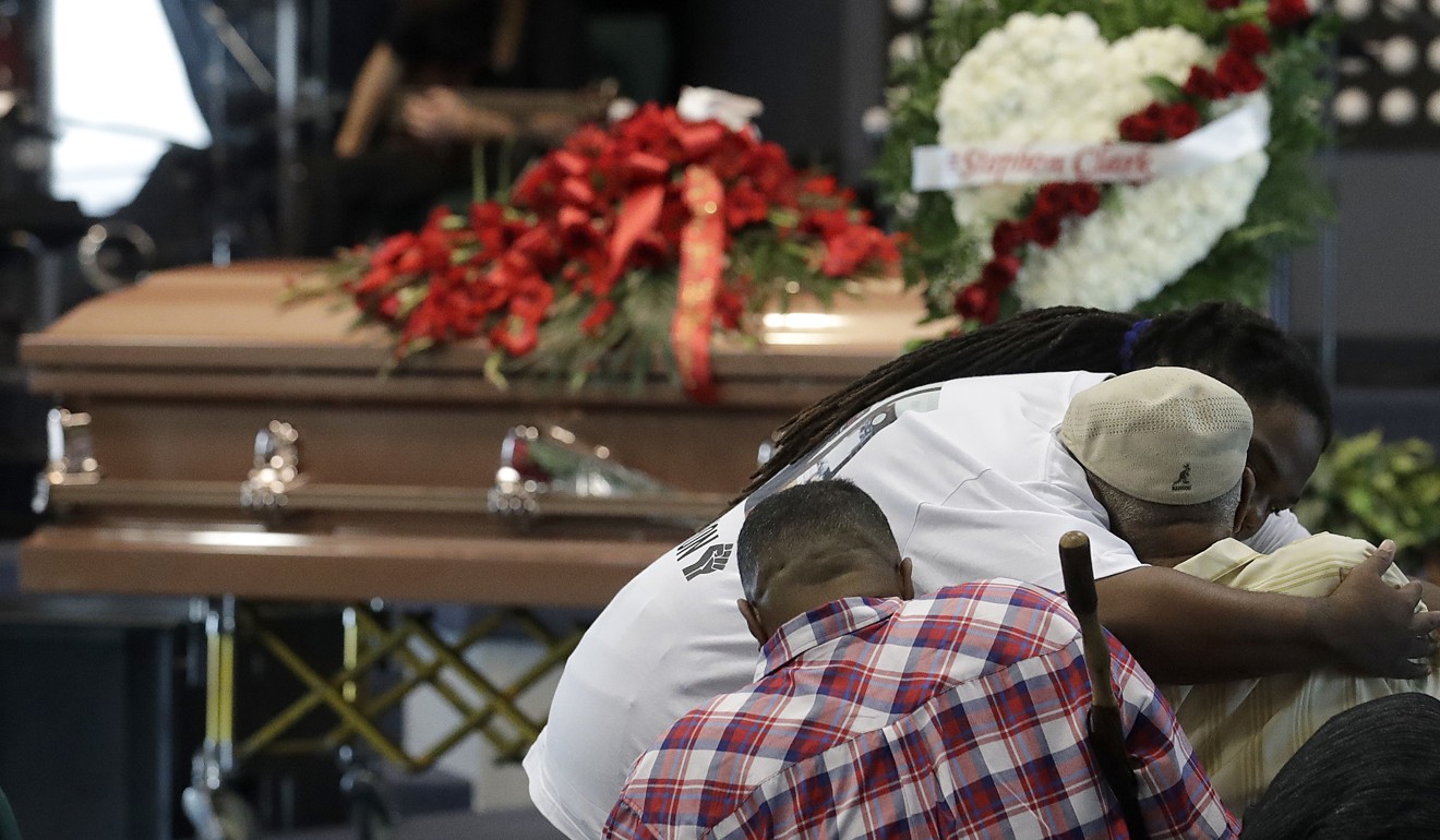 A man hugs another man before funeral services on Thursday for Stephon Clark at Bayside of South Sacramento Church, known as BOSS Church. Photo: AP 