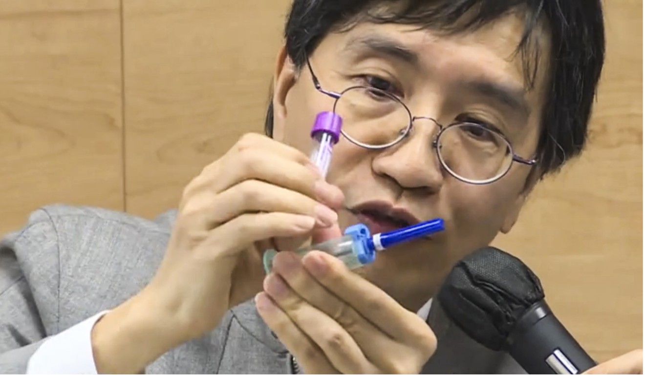 Professor Yuen Kwok-yung explains how the blood collection tube holder may have been the main channel for the transmission of the virus. Photo: Cable TV