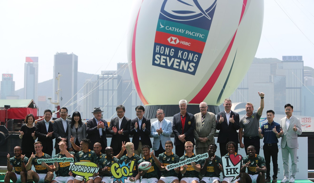 The giant rugby ball towers over officials, guests and the South Africa team at its unveiling.