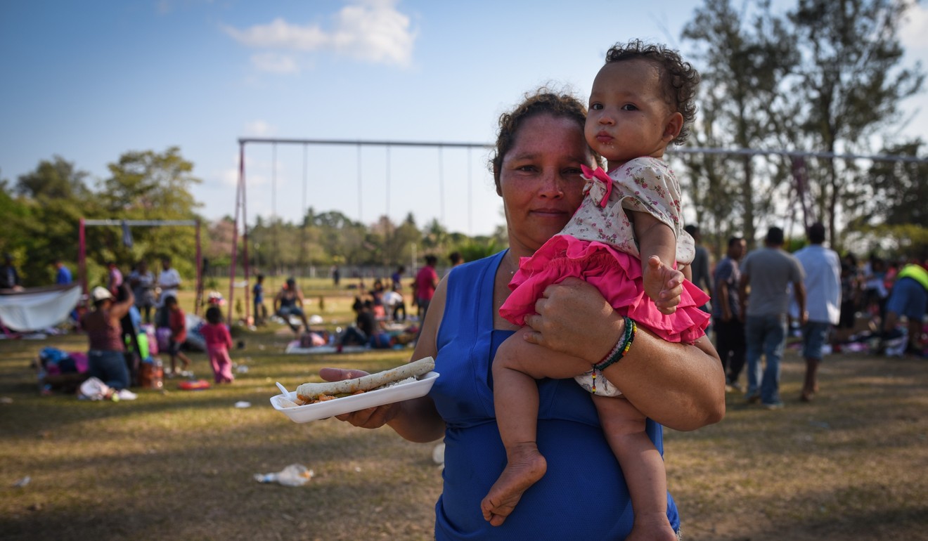 A Central American migrant and her daughter taking part in the ‘Migrant Via Crucis’ caravan in Mexico receive breakfast on Wednesday in Matias Romero, Oaxaca state. Photo: AFP