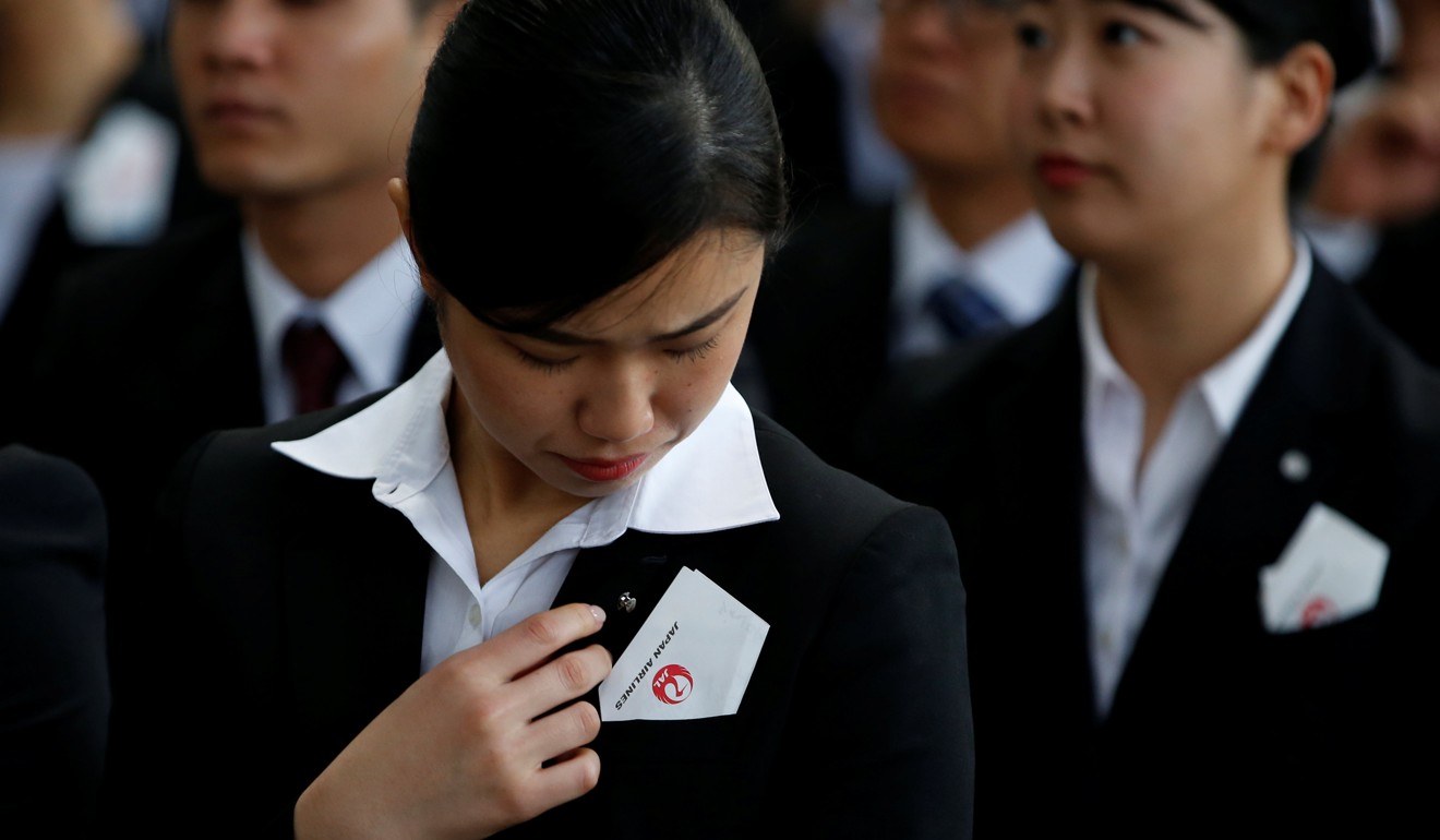 Newly-hired employees of the Japan Airlines group attend the company’s initiation ceremony at a hangar in Haneda airport, Tokyo, on April 2. The string of “lost decades” in Japan, modern Asia’s first troubled growth miracle, offers lessons for the Chinese economy. Photo: Reuters 
