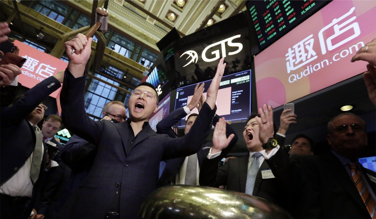 Qudian CEO Min Luo (left) and chief financial officer Carl Yeung ring the ceremonial bell at the New York Stock Exchange on the first day of trading of the company’s initial public offering in October 2017. Photo: AP