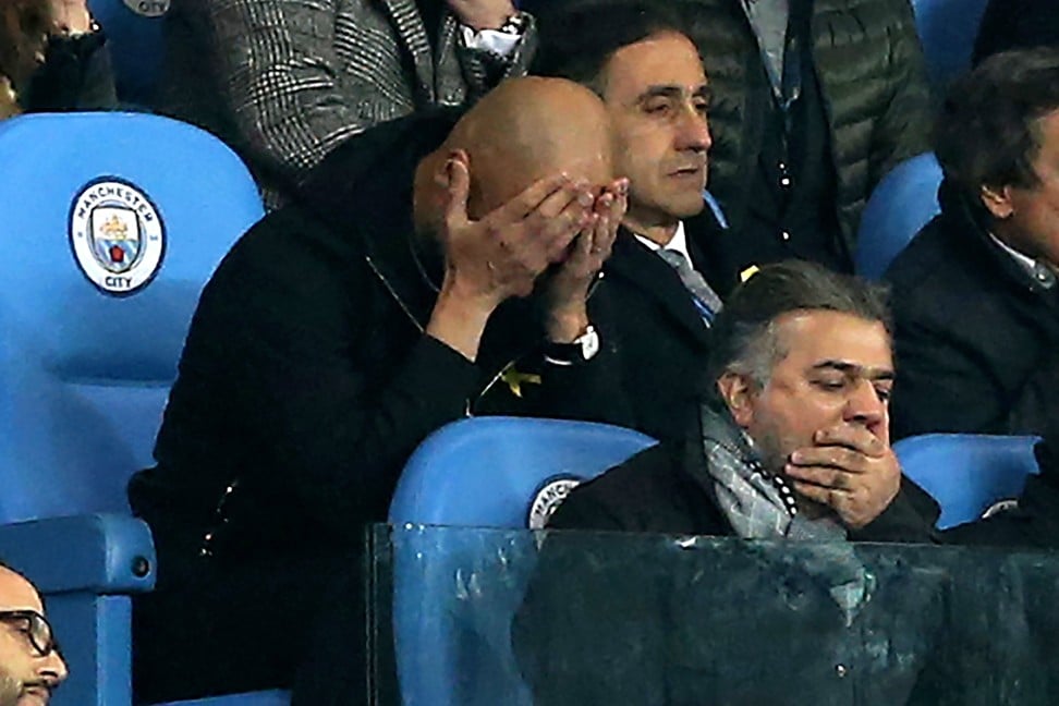 Pep Guardiola (left) watches on from the stands after he has been sent off. Photo: EPA