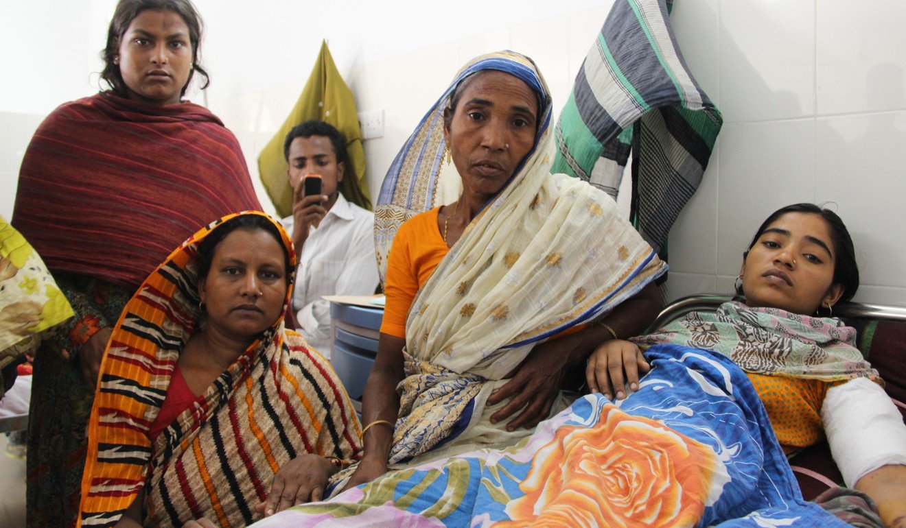 A Rana Plaza survivor with family and friends. Photo: International Labour Organisation