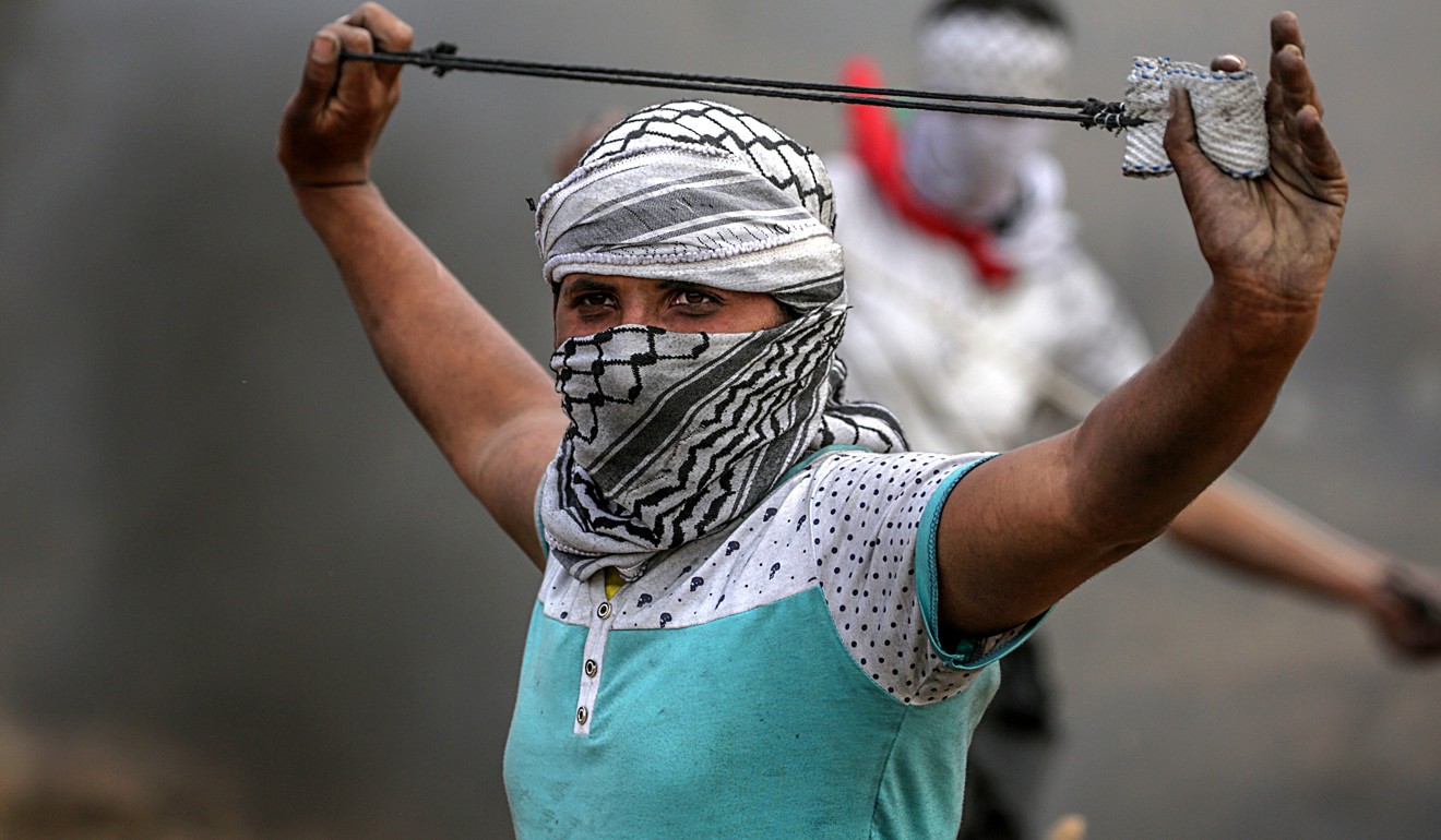 A Palestinian protester uses a slingshot during clashes near the border with Israel on Friday. Photo: EPA-EFE