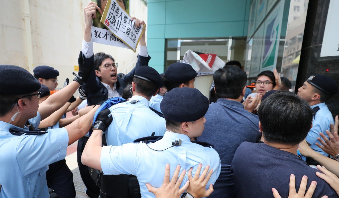 Members of the League of Social Democrats protest in Tsim Sha Tsui where Qiao Xiaoyang is speaking at an event. Photo: Winson Wong