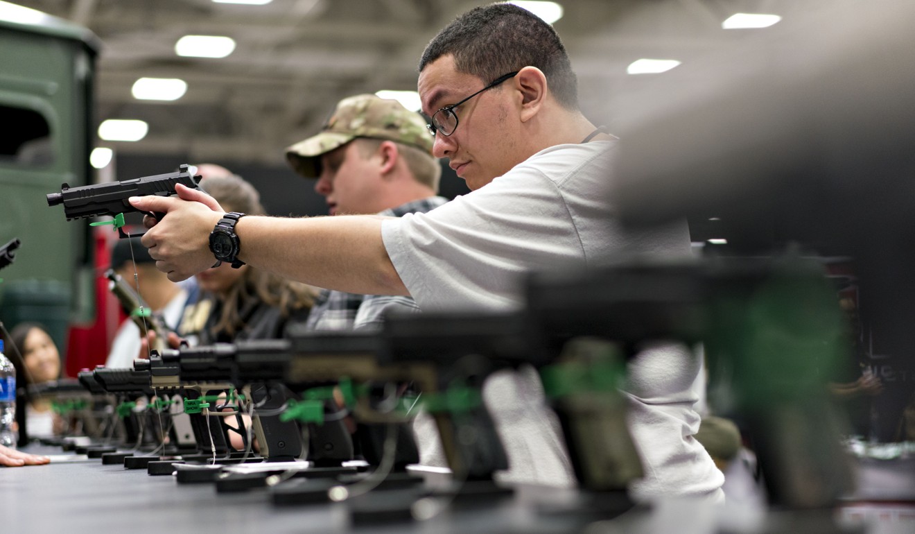 An attendee holds a pistol during the National Rifle Association (NRA) annual meeting in Dallas, Texas. Photo: Bloomberg
