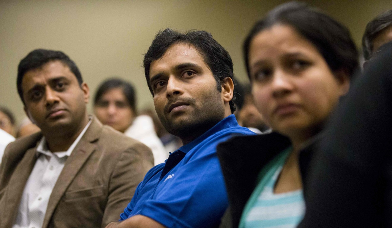Alok Madasani, a victim in the Kansas attack, listens as the sister of victim Ian Grillot addresses a prayer vigil at the Ball Conference Center in Olathe, Kansas on January 22, 2017. Photo:  AFP / Getty Images North America