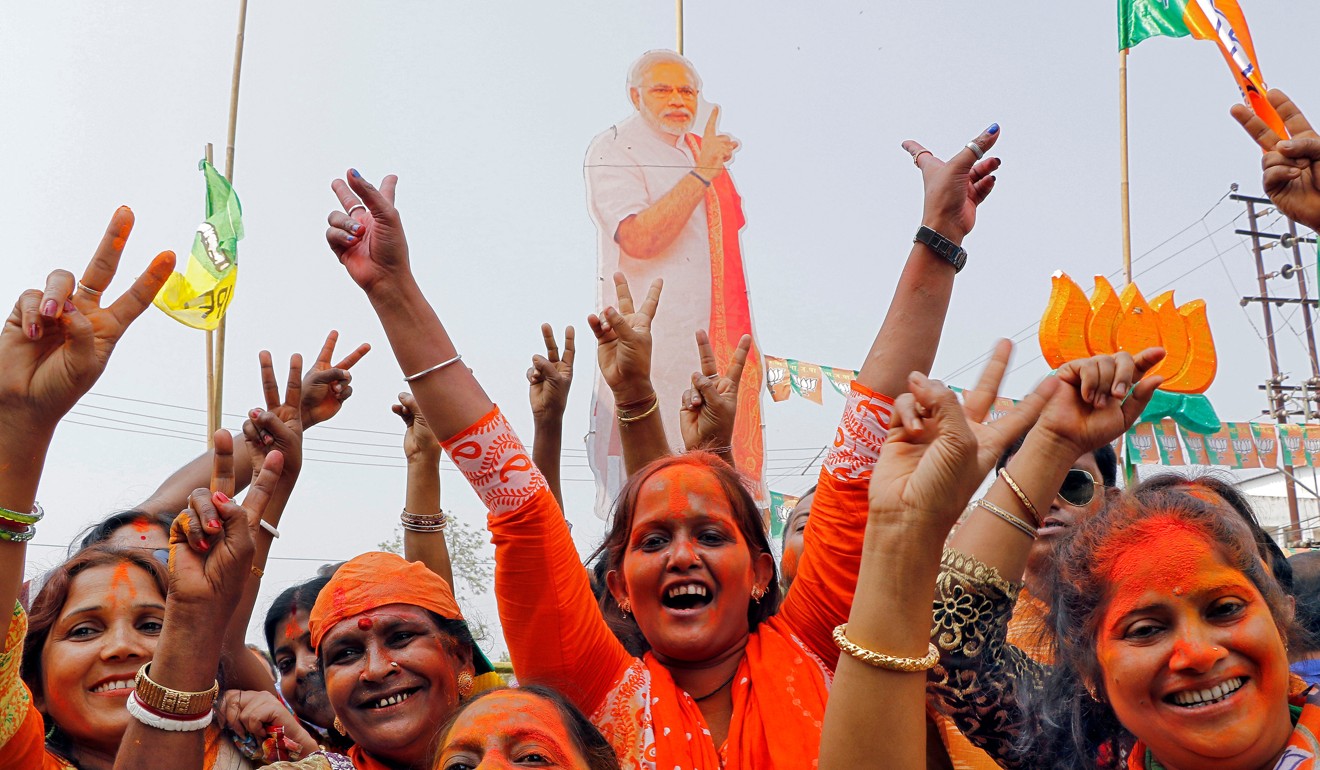 Supporters of India's ruling Bharatiya Janata Party celebrate in front of a cut-out of Prime Minister Narendra Modi after learning of the initial poll results of Tripura state assembly elections in Agartala on March 3. Photo: Reuters