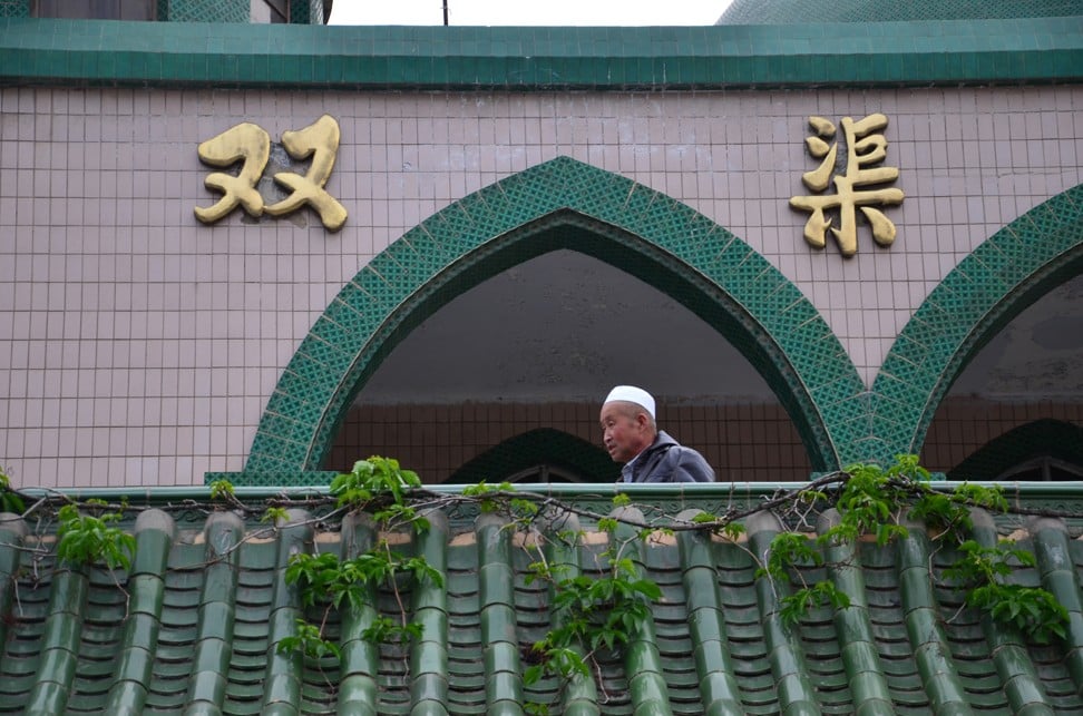 A Hui man attends evening prayer at a mosque in Yinchuan that will be torn down to make way for a road-widening project. It is being rebuilt next door in traditional Chinese temple style. Photo: Nectar Gan