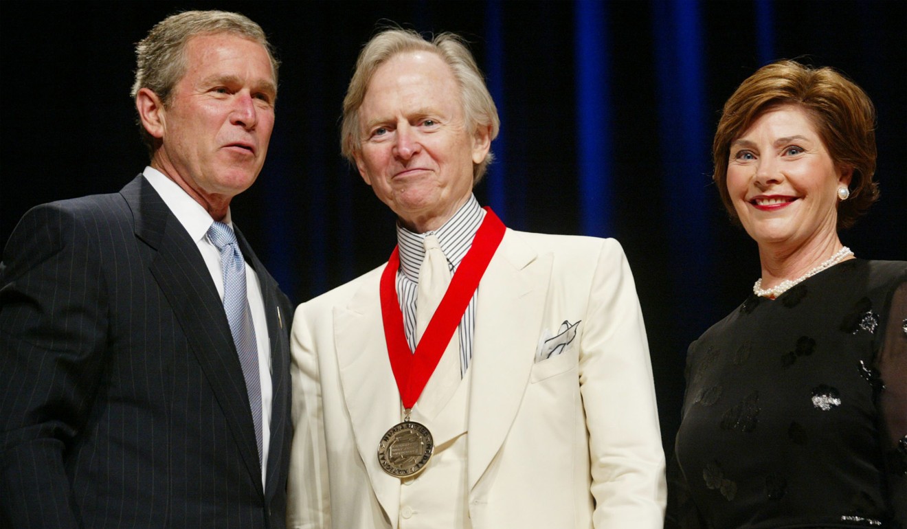 US President George W. Bush and his wife, Laura, with writer Tom Wolfe after he was awarded the National Humanities Medal in 2002. Photo: AP