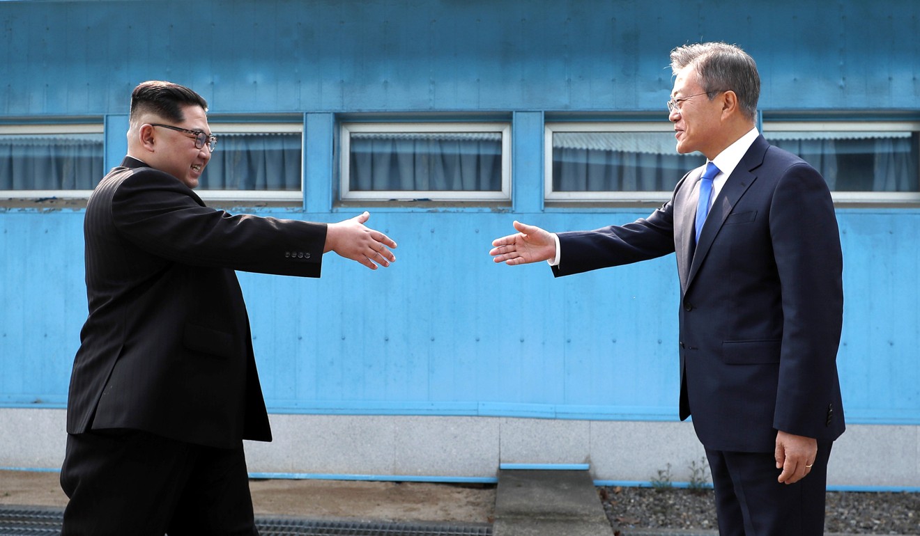 North Korean leader Kim Jong-un (left) prepares to shake hands with South Korean President Moon Jae-in over the military demarcation line in Panmunjom, in the demilitarised zone, on April 27. Photo: Pool via AP 