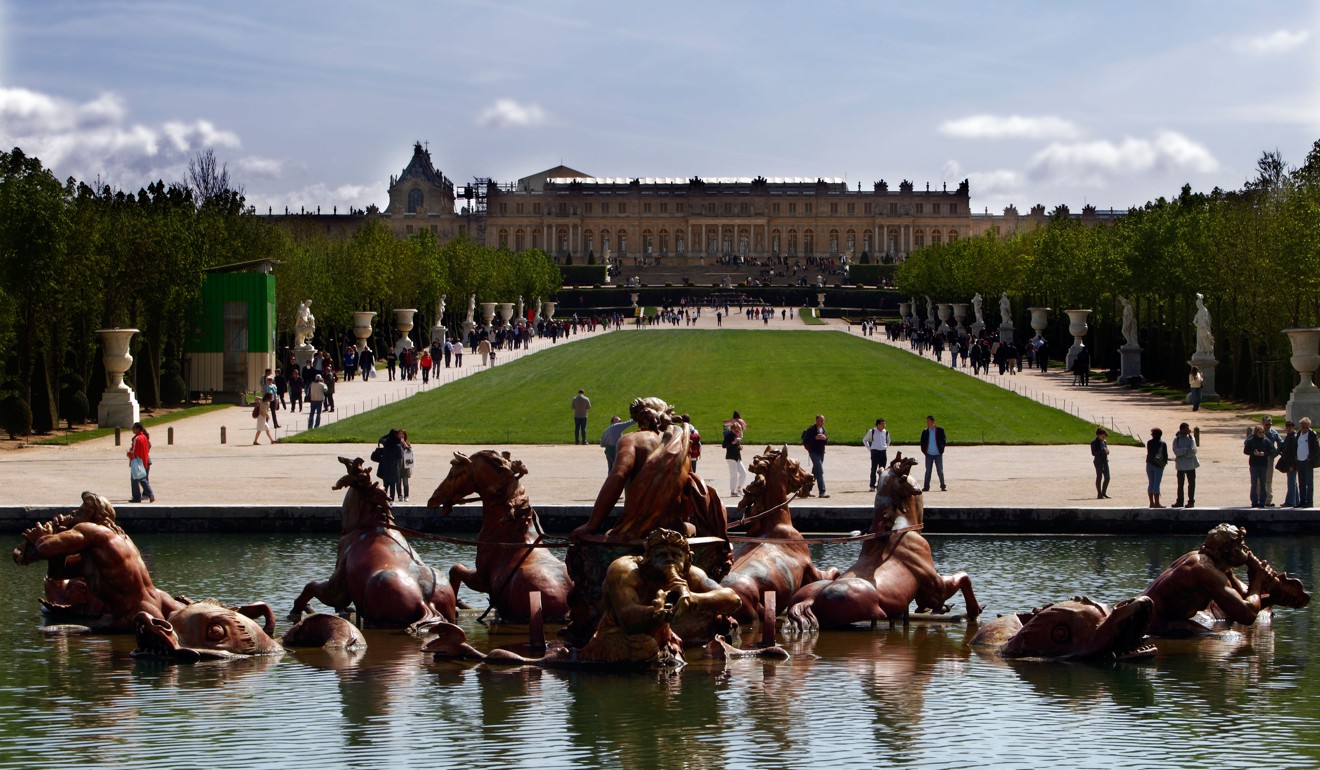 The view up to the Palace of Versailles from the rondeau fountain of Apollo.