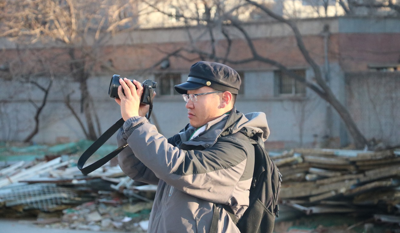 Photographer Wang Wei at Xihuangcun railway station, in Beijing, in December. Picture: Thomas Bird