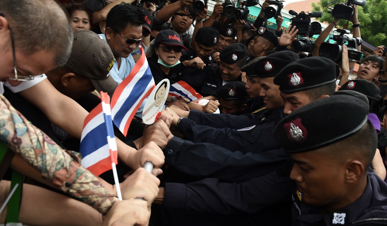 Protesters and police square off in Bangkok on the fourth anniversary of military rule in Thailand. Photo: AFP