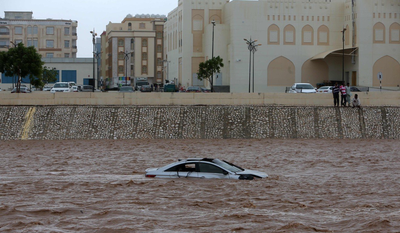 A car stuck in a flooded street in the southern Oman city of Salalah. Photo: AFP