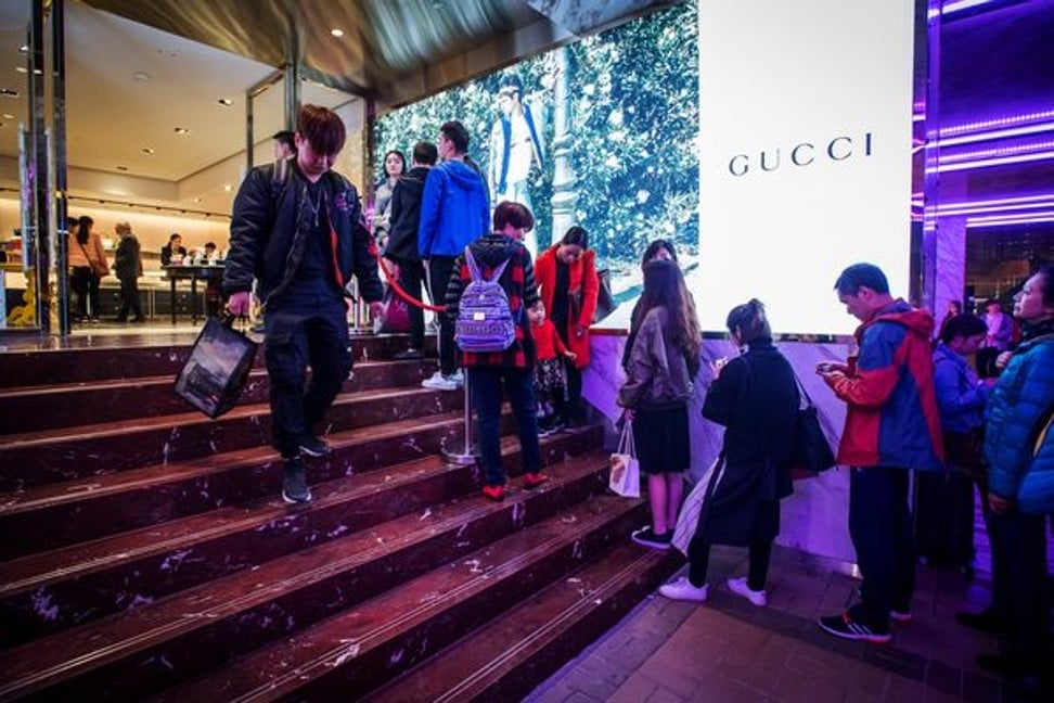 Shoppers wait in line at a Gucci store in Hong Kong. Photo: Bloomberg