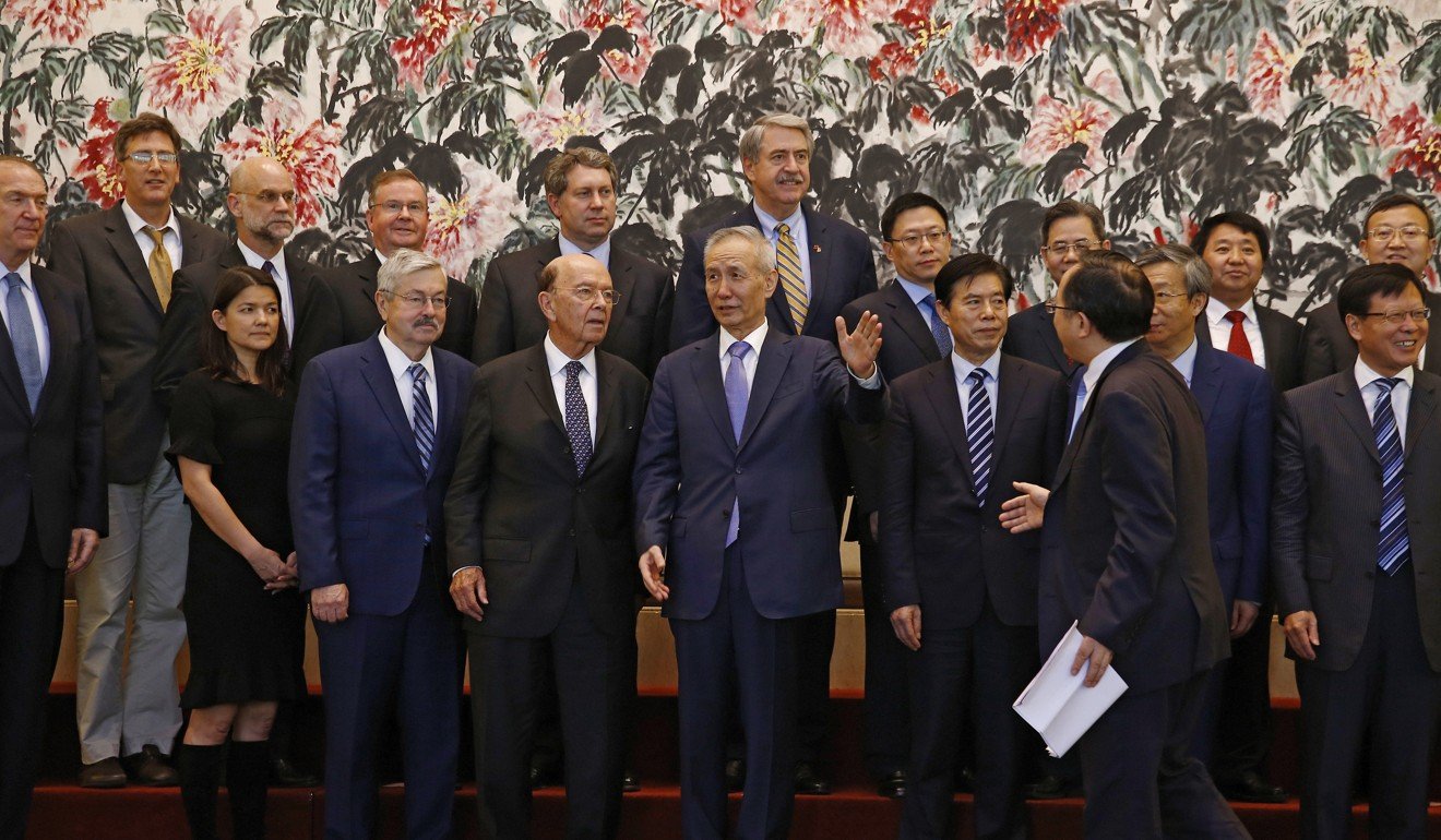 Members of the US and Chinese trade delegations in Beijing on Sunday. Photo: AP