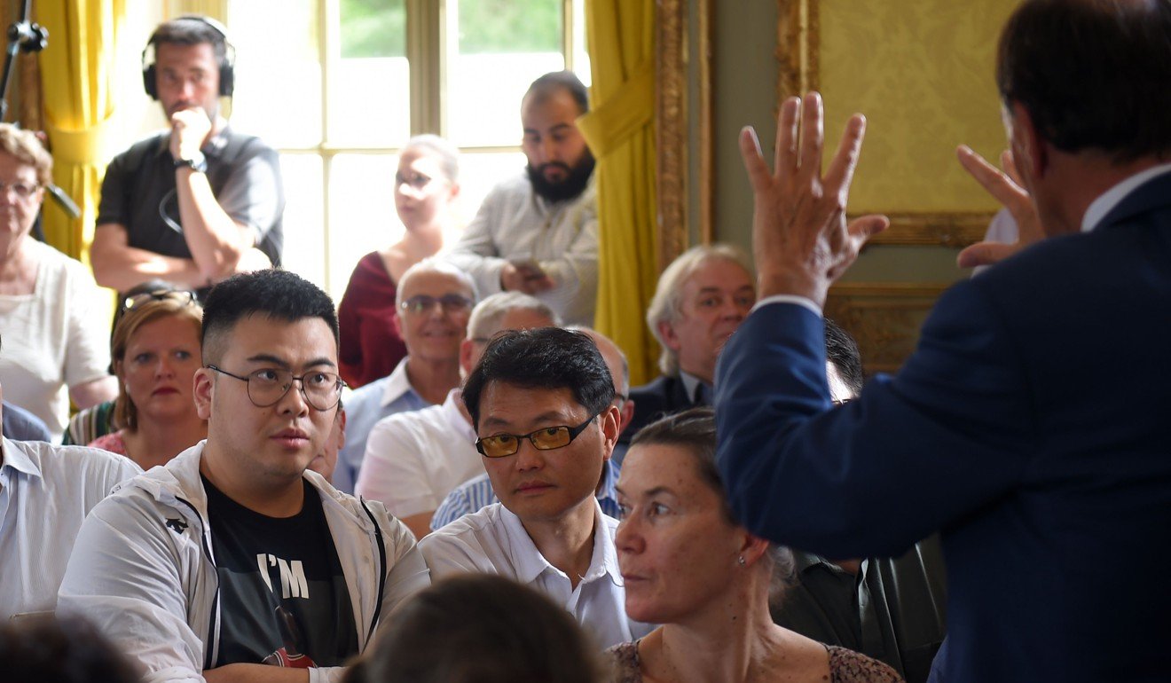 French auctioneer Philippe Rouillac (right) talks to Chinese buyers during an auction party on Sunday. Photo: AFP