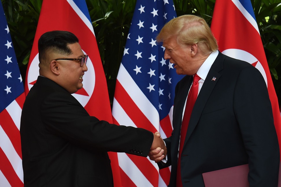 North Korean leader Kim Jong-un shakes hands with US President Donald Trump after taking part in a signing ceremony at the end of their historic US-North Korea summit on Tuesday. Photo: AFP