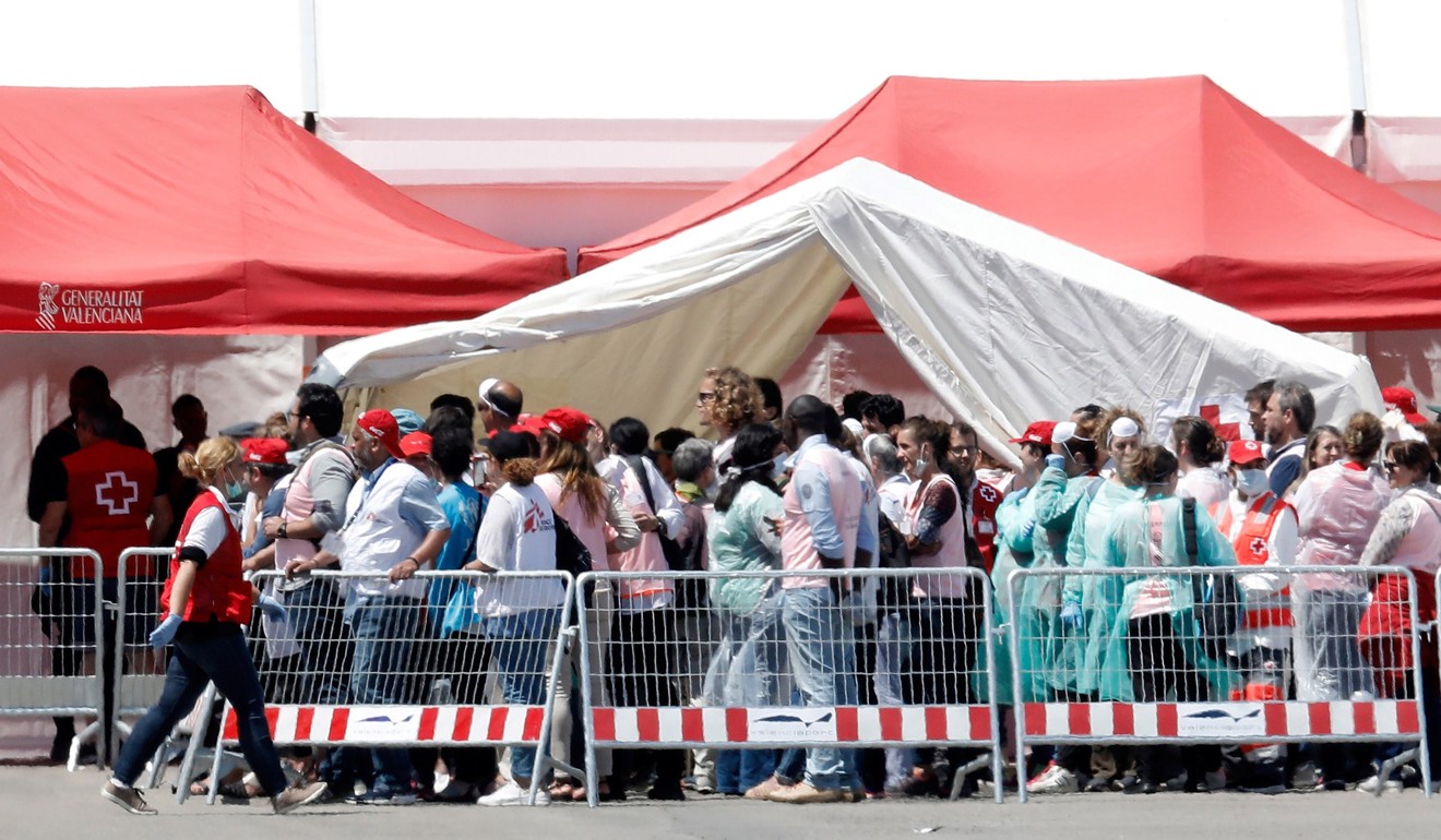 Some of the migrants wait to be attended to at the port in Valencia. Photo: EPA