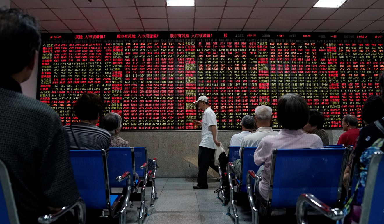 Investors monitor an electronic board posting stock information at a brokerage house in Shanghai, China, on Wednesday. Photo: Reuters