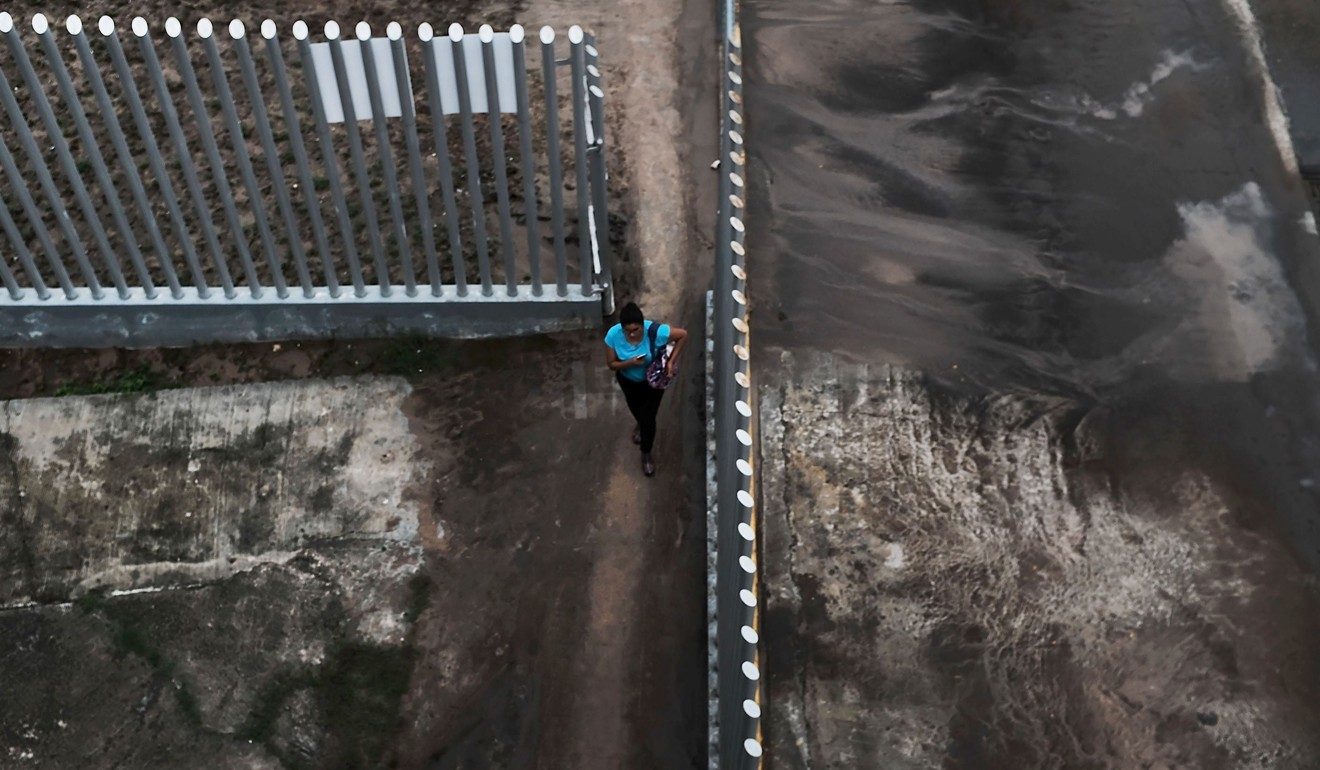 A woman walks to the border between Mexico and the United States on Thursday in Reynosa, Mexico. Photo: Getty Images/AFP