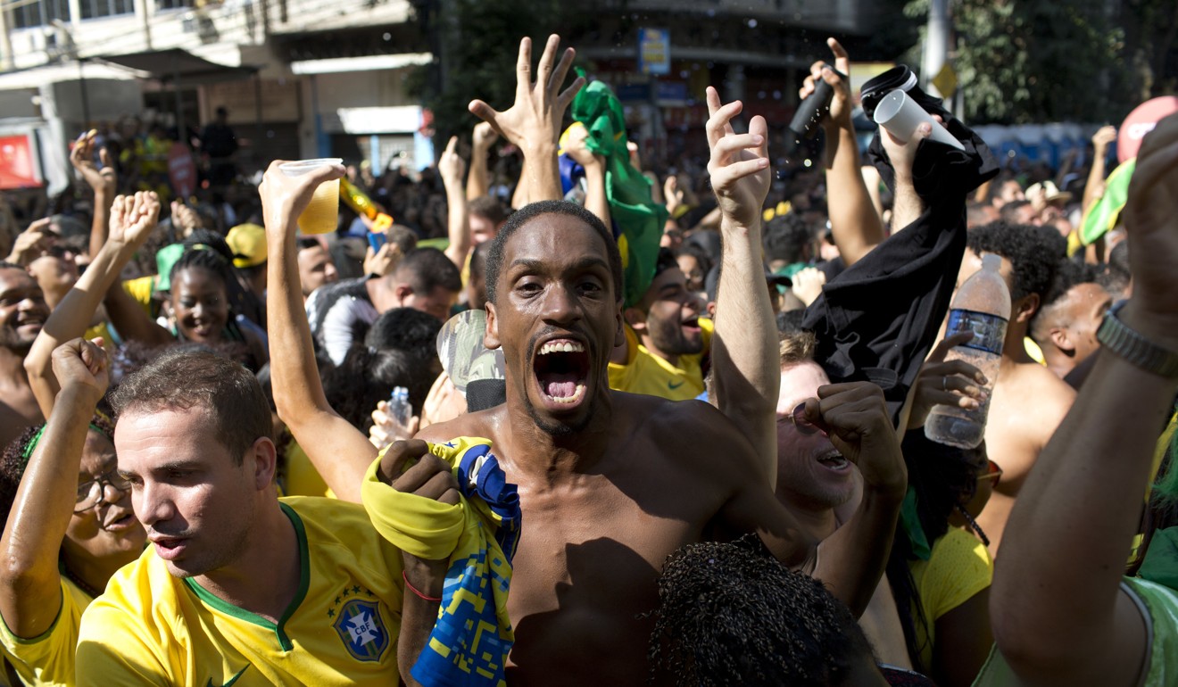 Brazil fans celebrate their team’s second goal against Mexico. Photo: AP